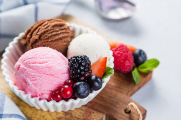 Selection of colorful ice cream scoops in white bowls