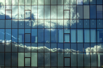 Cloudy reflections in the windows of the building