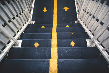 staircase with up and down yellow sign