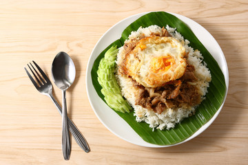 Fried rice in white plate and banana leaves.