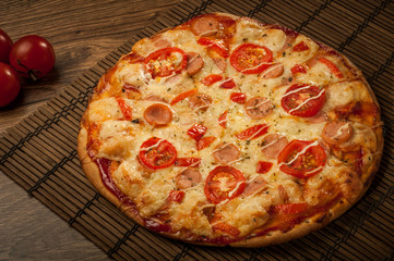 Hot pizza slice with melting cheese on a rustic wooden table
