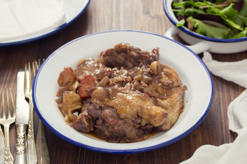 chicken prepared with red wine in white plate