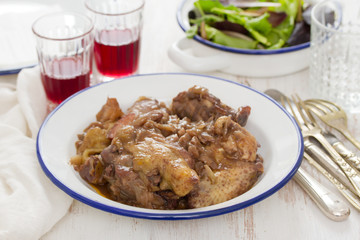 chicken prepared with red wine in white plate