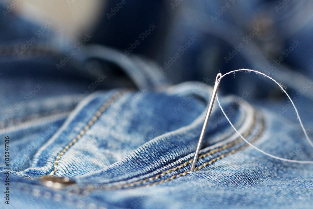 Wall mural The needle and thread on the jeans