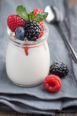 Homemade Panna Cotta with berries and mint in jar