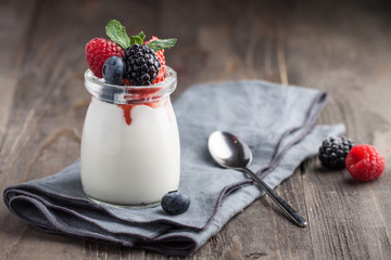 Homemade Panna Cotta with berries and mint in jar
