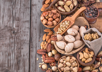 Naklejka premium Nuts on old rustic table with copy space