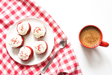 Morning breakfast with cup of black coffee and five red velvet pancakes on white. Top view.