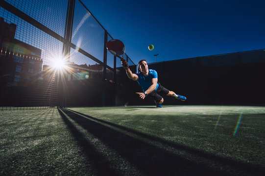 Young man playing paddle.