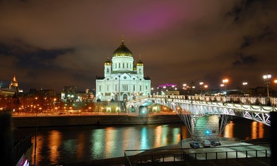 View of Temple of Christ Savior at night. Moscow, Russia/He stands on banks of  Moscow river, it leads to bridge. Taken late evening, before Christmas, festive illumination of city 