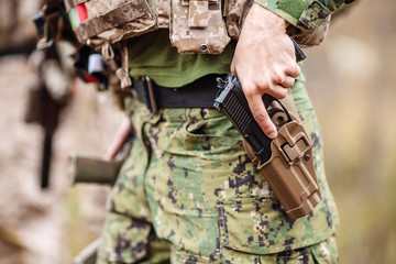 Fototapeta premium Ranger wearing uniform with gun in hand,keep gun in the holster. military concept