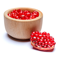 Pomegranate seeds in wooden bowl close-up