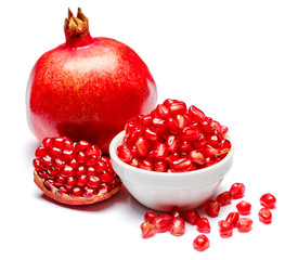 Pomegranate and seeds in ceramic bowl close-up