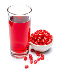 Pomegranate juice and fruit in ceramic bowl close-up