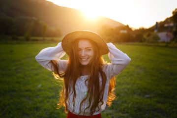 Fototapeta premium Summer portrait, beautiful freckled young woman wearing straw hat