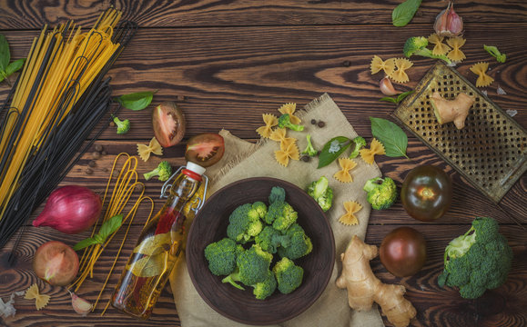 Top view of organic food and kitchen items on wooden background with copy space