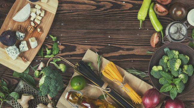Fresh organic vegetables and kitchen items on wooden background. Top view. Copy space