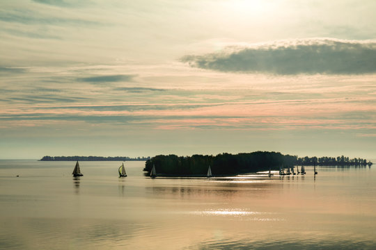 Sunrise over the river with yachts on a calm water surface