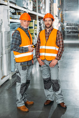 two male workers holding walkie talkie in shipping stock