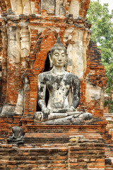 Buddha statue in Old Buddhist Temple Wat Mahathat Ayutthaya Historical Park, Ayutthaya, Thailand.
