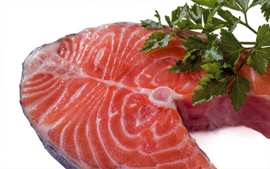 Salmon steak and parsley isolated on a white background.