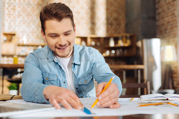 Diligent working.  Joyful focused concentrated guy working  while executing plan and enjoying 