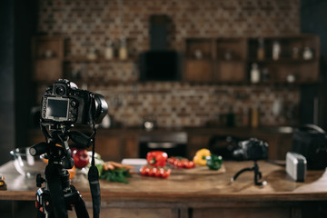 cameras and vegetables on table for food blog