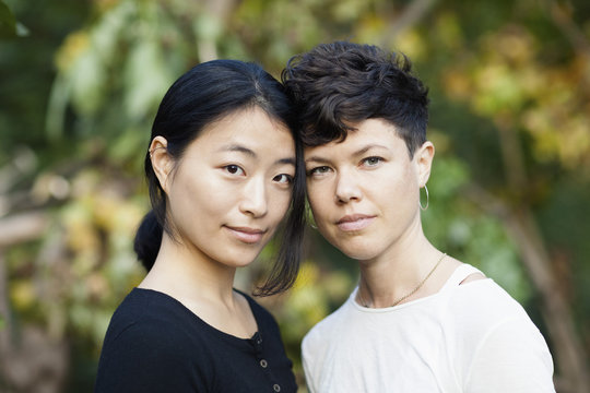 Portrait of lesbian couple standing at park