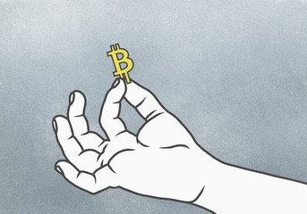 Cropped hand of man holding Bitcoin symbol against gray background