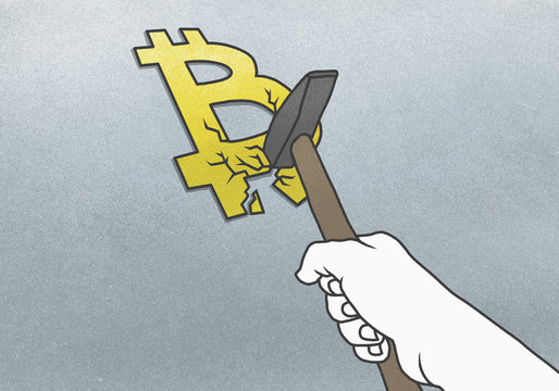 Cropped hand breaking Bitcoin symbol with hammer on gray background