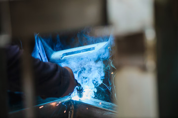 Close-up of welder's hands in working process