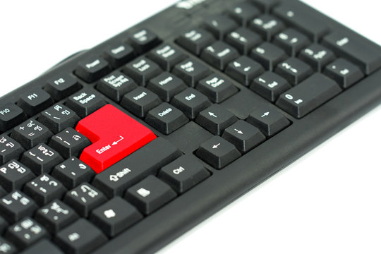Black keyboard with red enter bottom isolated on white