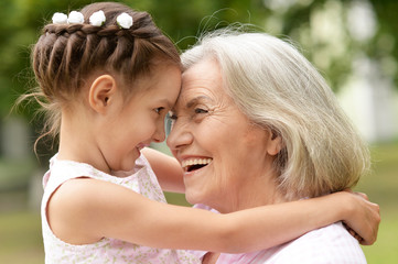 granny and granddaughter posing outdoors