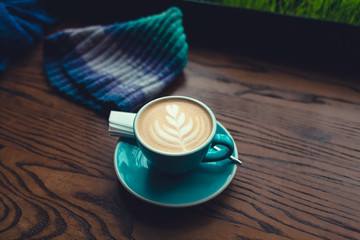 Cup of coffee on a wooden table.