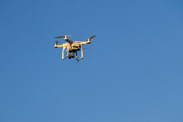 Fototapeta na wymiar drone with the camera hovering in blue sky