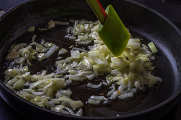 The cook fry in a frying pan on an induction cooker bow