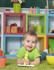 little boy playing with toy at home or kindergarten