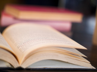 Open book on working desk in the library room with blurred focus for background, education back to school concept