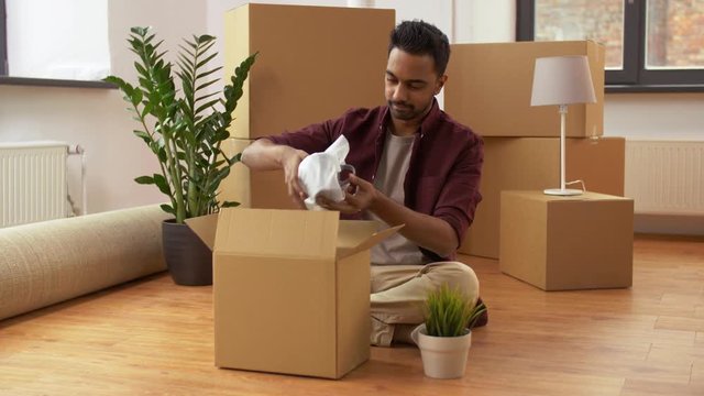 man packing boxes and moving to new home