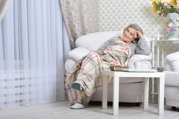 Fototapeta premium Senior woman resting at home with tea cup