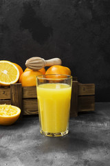 Fototapeta na wymiar Oranges and fresh orange juice on a black background