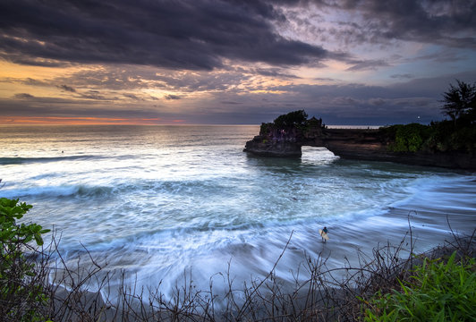 Sunset and surving at Tanah Lot, Bali, Indonesia