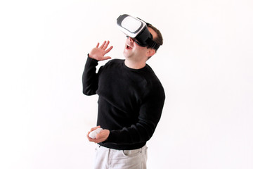 Handsome man wearing and playing virtual reality glasses on white background. Boy action in virtual reality helmet. Virtual reality headset. Young business man at office and using virtual reality box.