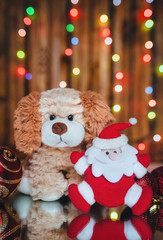 The dog is a symbol of 2018. Toy Santa Claus. Festive postcard.