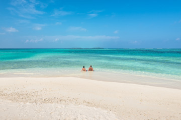 Fototapeta na wymiar Couple relaxing on paradise beach