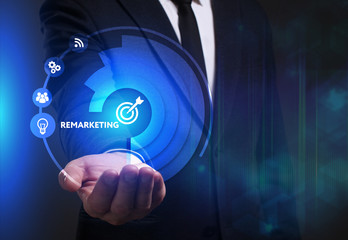 Business, Technology, Internet and network concept. Young businessman working on a virtual screen of the future and sees the inscription: Remarketing