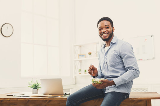 Young Business Woman Eating Salad At Office