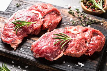 Raw beef steak with herbs.