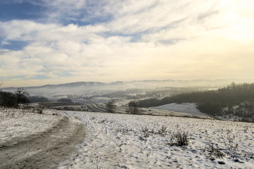 Fototapeta na wymiar foggy winter day over hills