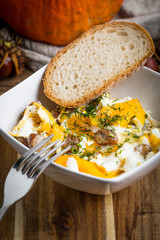 Scrambled eggs with sausage and bread.
